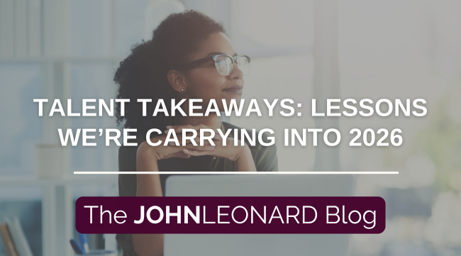 Person with glasses sitting in front of a laptop with hands folded beneath chin and looking out a window with a soft smile. A text overlay says "talent takeaways: lessons we're carrying into 2026" with The JOHNLEONARD Blog below.