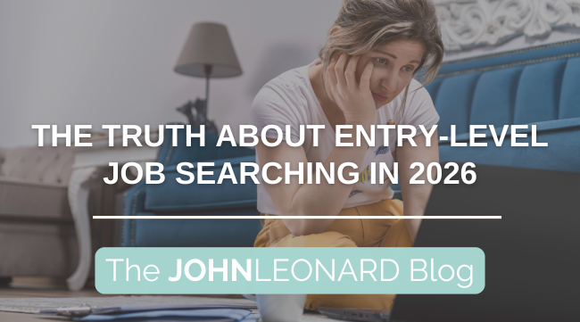 Person sitting on the floor with a laptop, holding their head and looking stressed, with text reading “The Truth About Entry-Level Job Searching in 2026” and “The JOHNLEONARD Blog.”